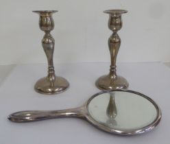 A pair of loaded silver candlesticks with integral vase shaped sockets  Birmingham 1923  7"h; and