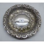 A white metal dish (possibly Portuguese silver coloured metal) impressed with floral designs    10"