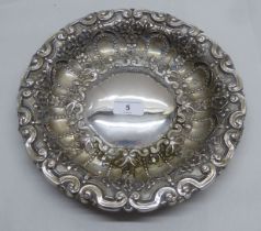 A white metal dish (possibly Portuguese silver coloured metal) impressed with floral designs    10"