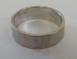 An 18ct spot-hammered, white gold wedding band