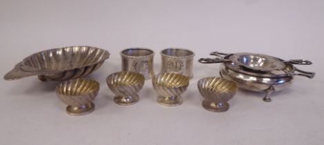 Silver items, viz. a pair of bead and reel bordered napkin rings; a set of four demi-reeded pedestal