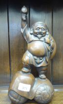 A Japanese patinated bronze figure 'Old Daikokuten'  13"h