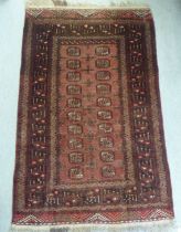 A Bokhara rug, decorated with elephant foot motifs, on a red ground  43" x 62"