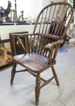 A late 18thC ash and elm high hoop back Windsor chair with a solid seat, raised on turned, tapered