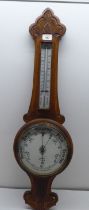 An Edwardian aneroid barometer/thermometer with a painted enamel dial  33"h