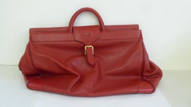 A Longchamp red hide holdall