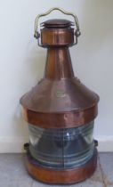 An early 20thC copper and brass cased bulkhead lantern, comprising a covered chimney with a