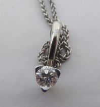 A platinum pendant, set with a round cut diamond, on a platinum chain