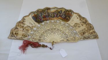 A late Victorian bone fan with engraved, pierced and gilded sticks and guards, the painted panel