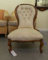 A late Victorian carved satin mahogany showwood framed spoonback lady's chair, upholstered in