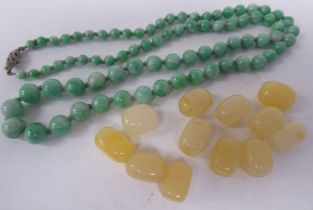 Spherical and elongated jade coloured beads