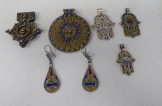 White metal and coloured enamel pendants: to include four hamsa examples