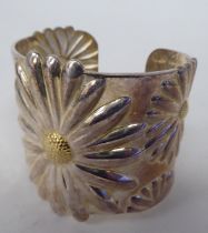 A white metal bangle, decorated in floral designs  stamped  925