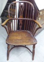 A 19thC elm and beech framed splat and spindled back Windsor chair, the solid seat raised on