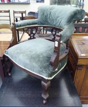 An Edwardian mahogany framed salon chair with a blue fabric upholstered back and seat, raised on