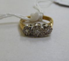 An 18ct gold three stone diamond ring