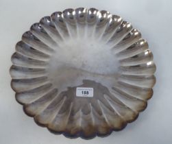 A silver coloured metal dish with lobed decoration  stamped BCB .9584  13"dia