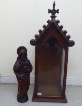 A late 19thC carved oak standing figure, Christ with an orb  22"h; in a contemporary, fully