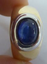 A bi-coloured metal signet ring, set with a cabochon sapphire  stamped 585