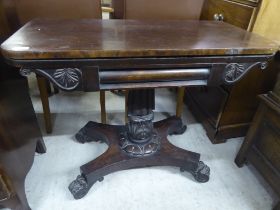 A mid Victorian flame mahogany veneered card table, the rotating foldover top raised on a carved