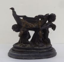 A 19thC cast bronze and parcel gilt classical group, two cherubic figures struggling to carry a