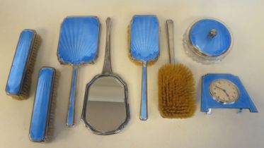 An Art Deco silver and powder blue engine turned enamel dressing table set: to include a powder bowl