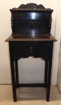 A late Victorian carved and stained oak side cabinet with a frieze drawer, raised on square legs