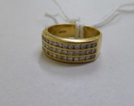 An 18ct gold ring, set with three tows of diamond chips