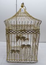 A late 19thC cream painted wire birdcage with a hinged domed top, pedant ring and applied palm