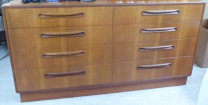 A G-Plan teak eight drawer dressing chest, on a plinth  30"h  56"w