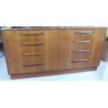 A G-Plan teak eight drawer dressing chest, on a plinth  30"h  56"w