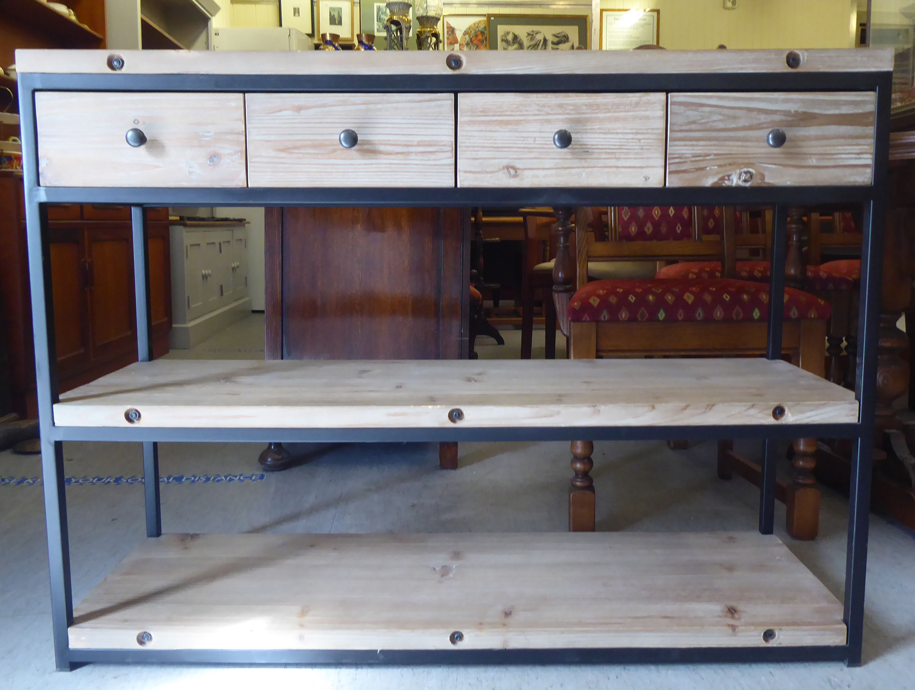 A Loaf steel framed and stained fir sideboard with four frieze drawers, over two open shelves,