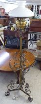 An early 20thC cast brass and wrought metal standard lamp  62"h