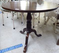A late 19thC mahogany pedestal tip-top table, raised on a tripod base   28"h  30"dia