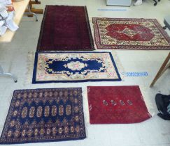 Five rugs: to include a Persian example, on a multi-coloured ground  48" x 64"