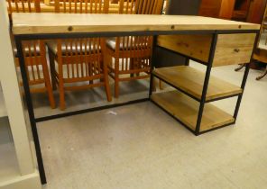 A Loaf steel framed and stained fir desk, over a single drawer and two open shelves, raised on