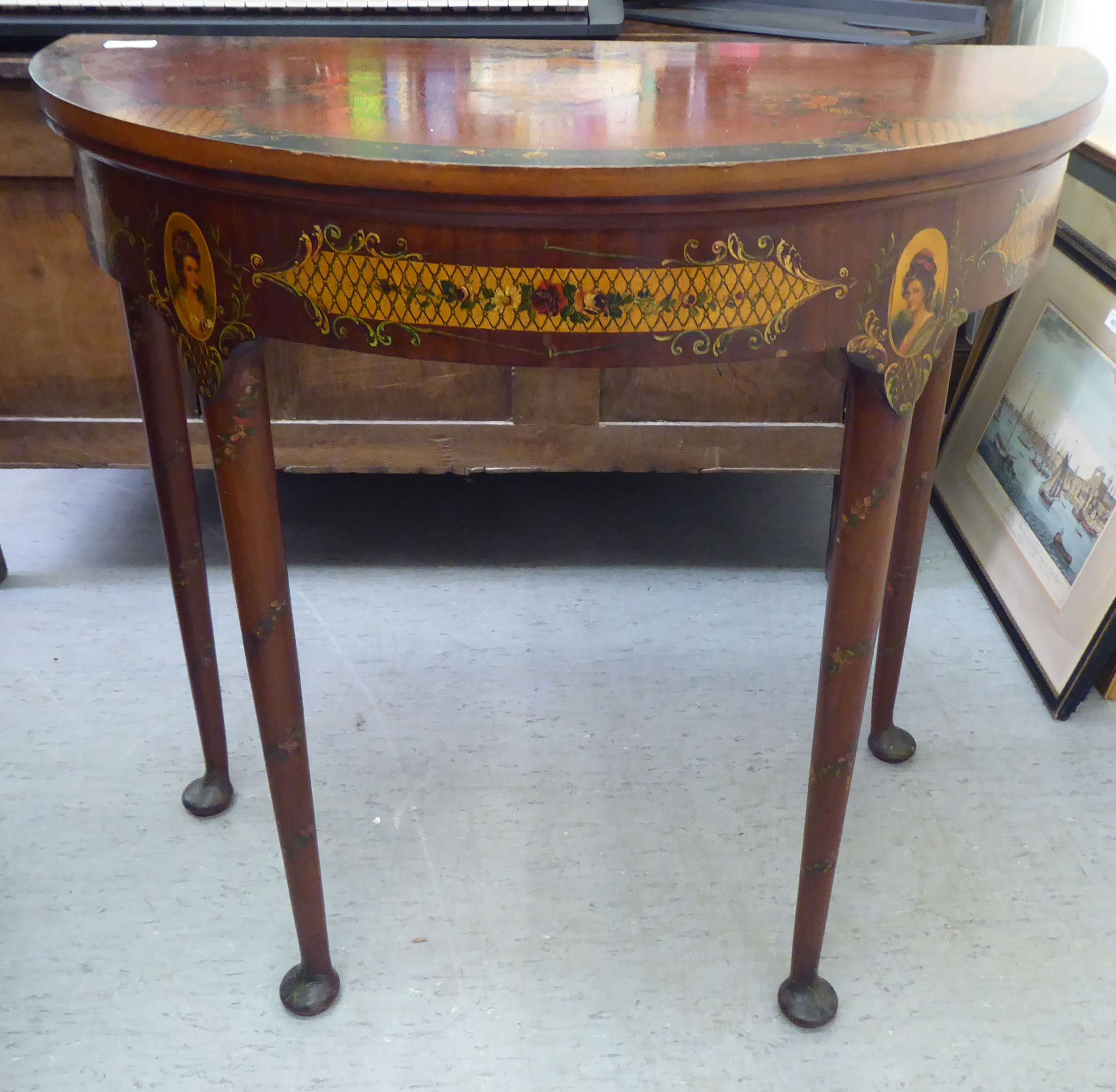 A late 19thC lacquered and painted, demi-lune card table, decorated with painted flora and