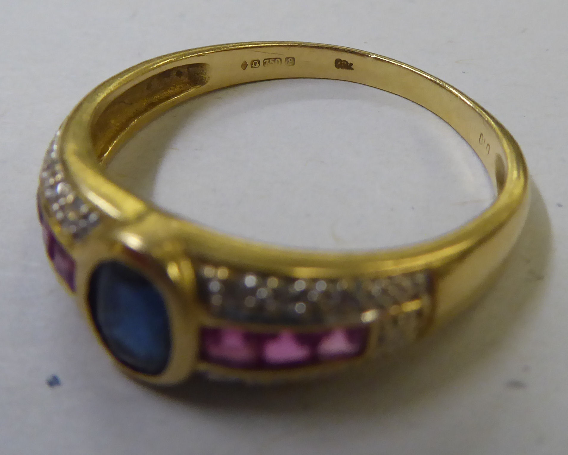 An 18ct gold ring, set with a central sapphire, ruby and diamond shoulders - Image 4 of 4