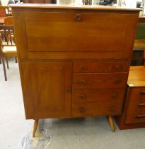 An Ercol stained elm cabinet, incorporating a fall front, over an arrangement of four drawers and