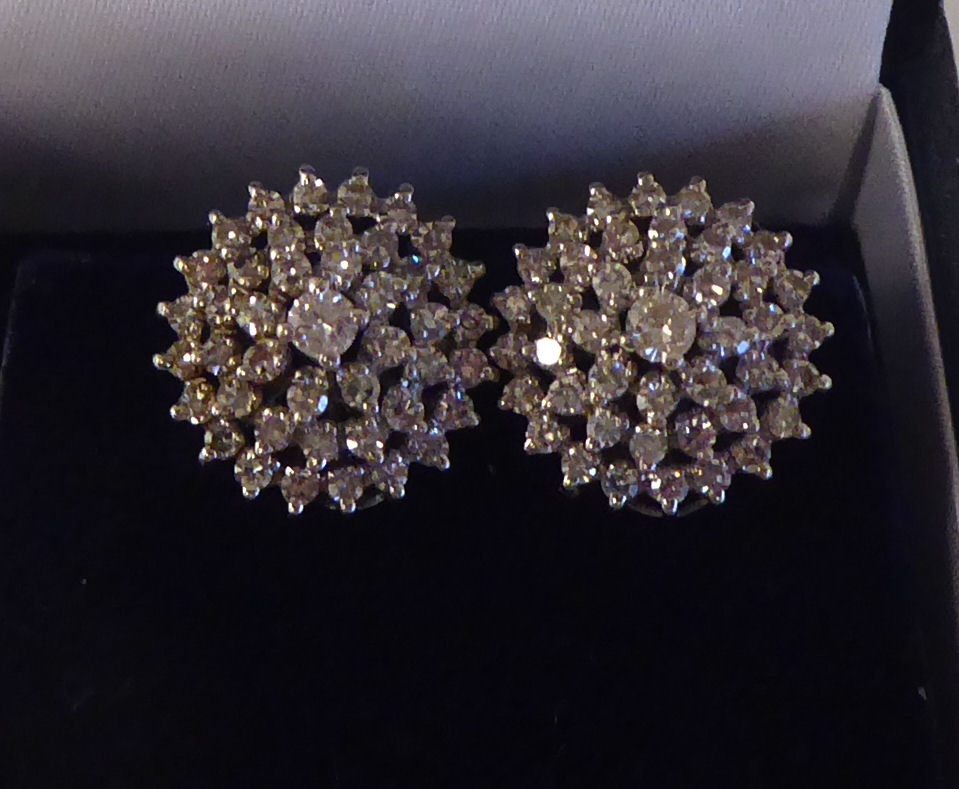 A pair of 14ct white gold, diamond set, cluster earrings