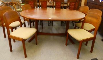 A Dyrlund teak draw leaf dining table, raised on splayed legs and feet  30"h  64"L with an