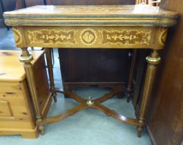 An early 20thC Continental inspired marquetry and kingwood veneered writing table, the hinged top
