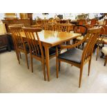 A 1960s/70s teak dining suite, comprising a draw leaf table, raised on square, tapered legs; and a