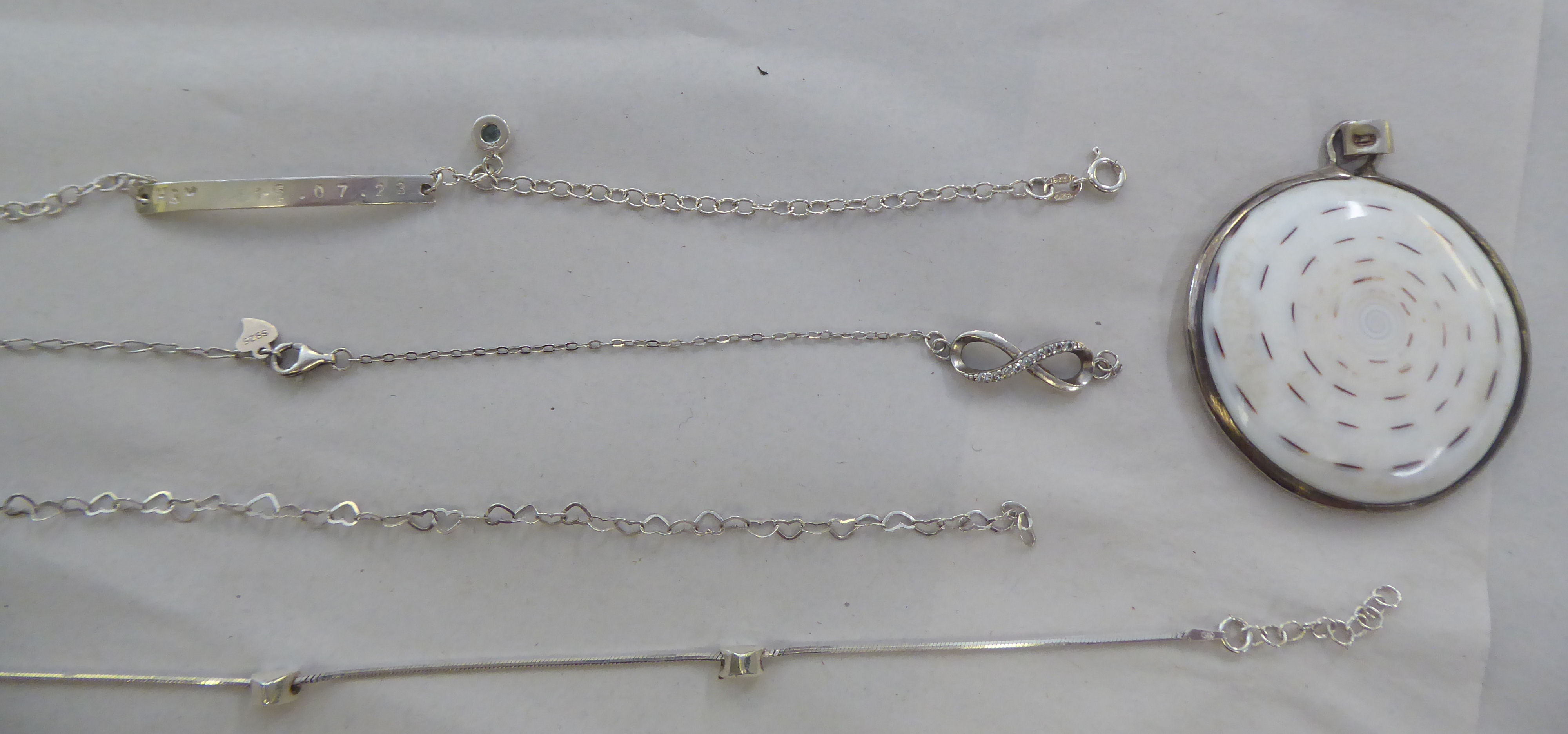 Silver coloured and white metal items of personal ornament: to include a pendant cross; and a - Image 6 of 6