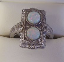 A silver coloured metal, cubic zirconia and opal set dress ring