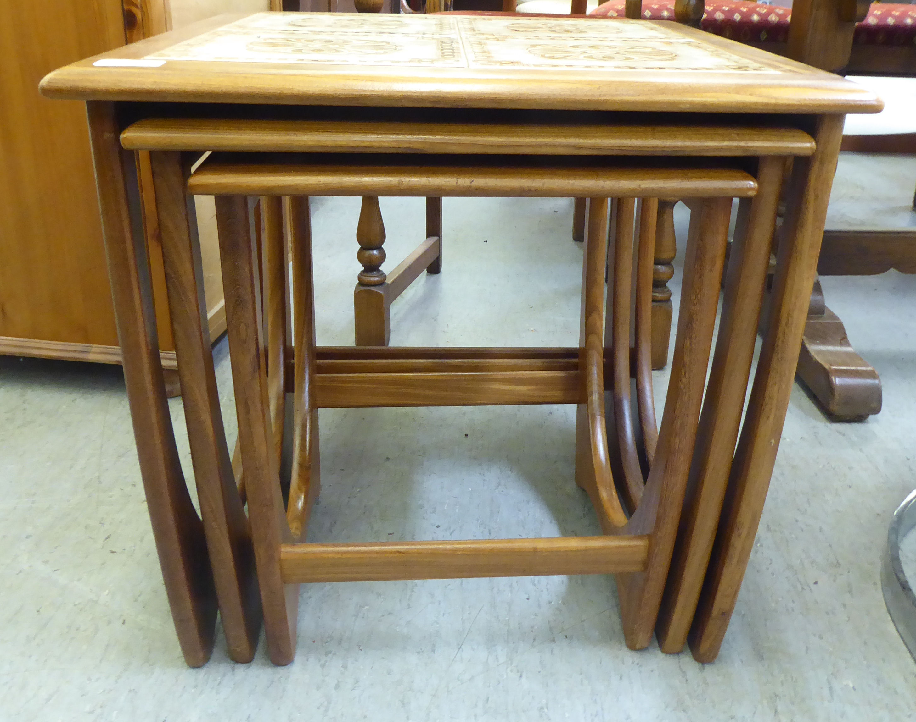 A nesting set of three G-Plan teak occasional tables, the largest top set with tiles, raised on - Image 3 of 5