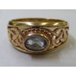 A 9ct gold ring with an unidentified blue stone