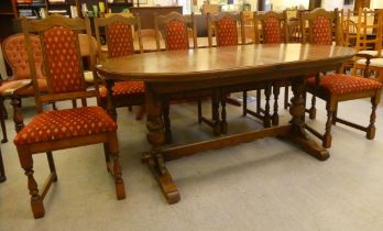 A Wood Bros Old Charm oak dining table, the oval top raised over a turned wooden base, united by a