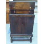 A 1930s oak canteen with a hinged lid, two drawers and a cabinet below  41"h  20"w; and silver