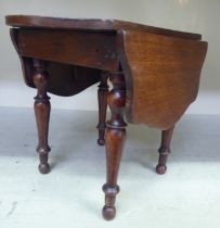A 19thC mahogany apprentice piece Pembroke table with butterfly fall flaps, raised on ring turned